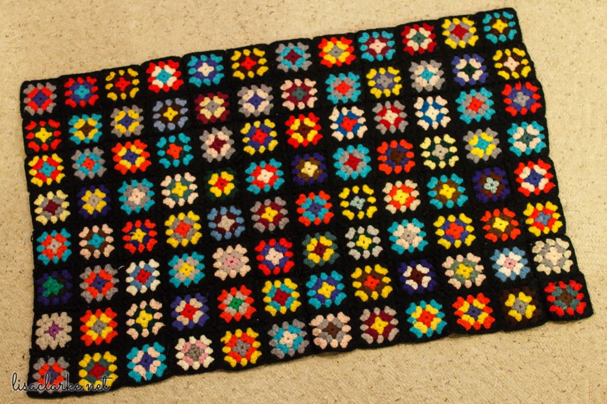 I assembled panels from a granny square sweater that my great-grandmother made for my mother 50+ years ago into this small blanket. All it needs is a border, and it will be done.
