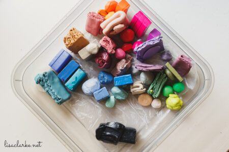Scrap Premo clay sorted by color, with a chunk of Kato Blackout separated from the rest